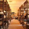 Warmly lit dorm room with wooden bunk beds and cozy atmosphere.